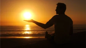 man seem holding the sun during sent symbolizing an Eternal Moment
