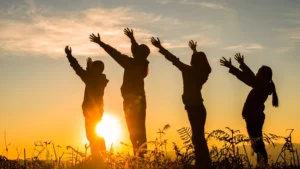 group pf people on a mountaain raising hands the founf the home of god