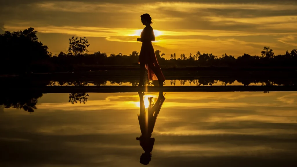 woman freely walking into the beach turning time into timelessness