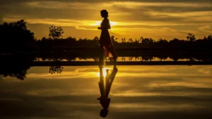 woman freely walking into the beach turning time into timelessness